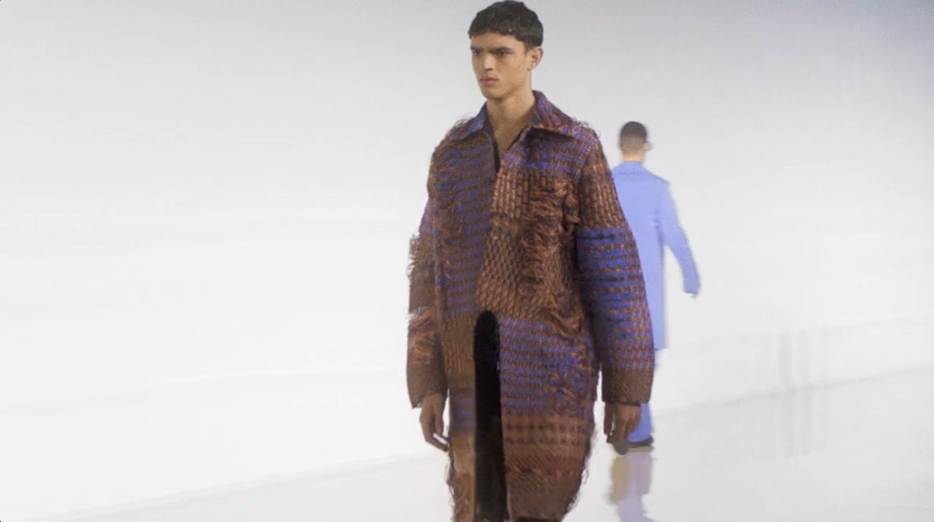 Robbie Barrat's open-source generative code became the center of a real controversy just two years before this show: in 2018, the French collective Obvious used code adapted from his published GAN work to create "Edmond de Belamy," a portrait that sold at Christie's for $432,500 as the first AI-generated artwork auctioned by a major house, without crediting or compensating him. So the same technology Acne framed as "freeing" had already exposed a very real question about who gets paid when a machine generates the output.