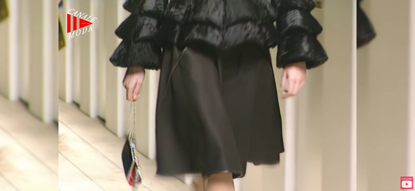 The FF logo itself was already almost 20 years old by this show. Lagerfeld had originally designed Fendi's interlocking double-F monogram back in 1981, meaning by Fall 2000 it had already become an established house code he was actively reinventing through print and sheer fabric, rather than something he was introducing for the first time.