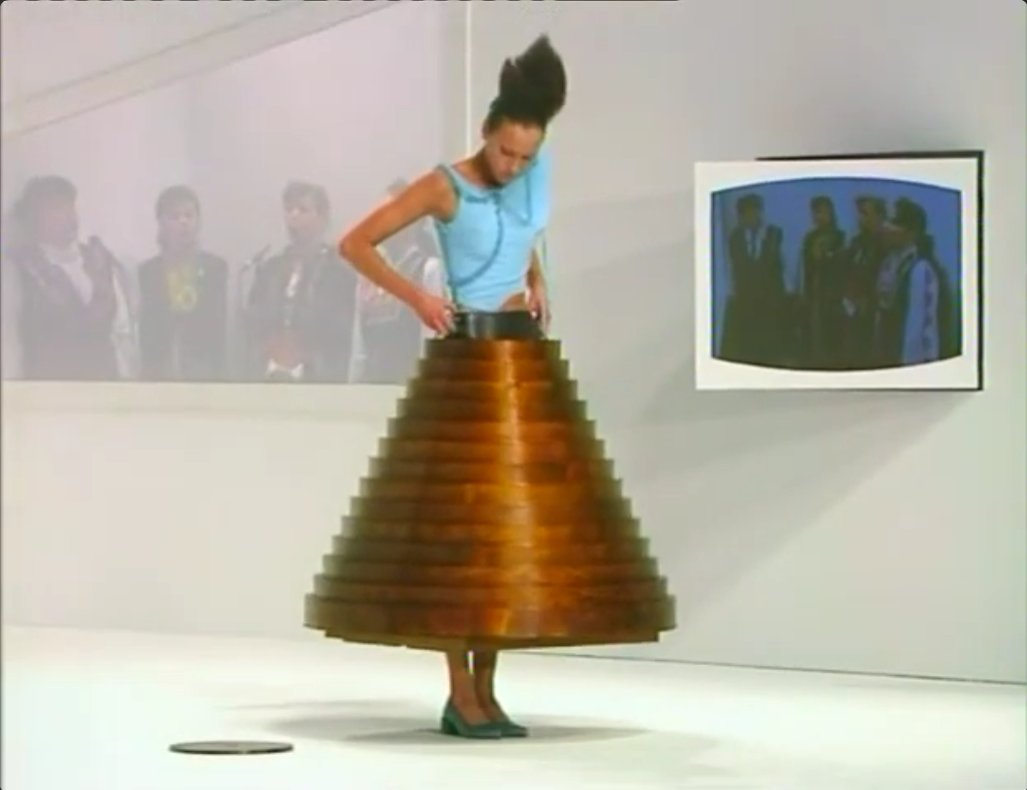The finale's most A model step into the center of a round coffee table, pull it up around her waist, and walk the runway wearing it as a rigid, telescoping skirt.