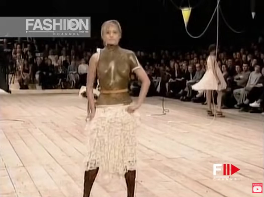 Paralympic athlete Aimee Mullins walking in hand-carved wooden prosthetic legs (made by Dorset Orthopedic over five weeks), which McQueen designed to look like boots.