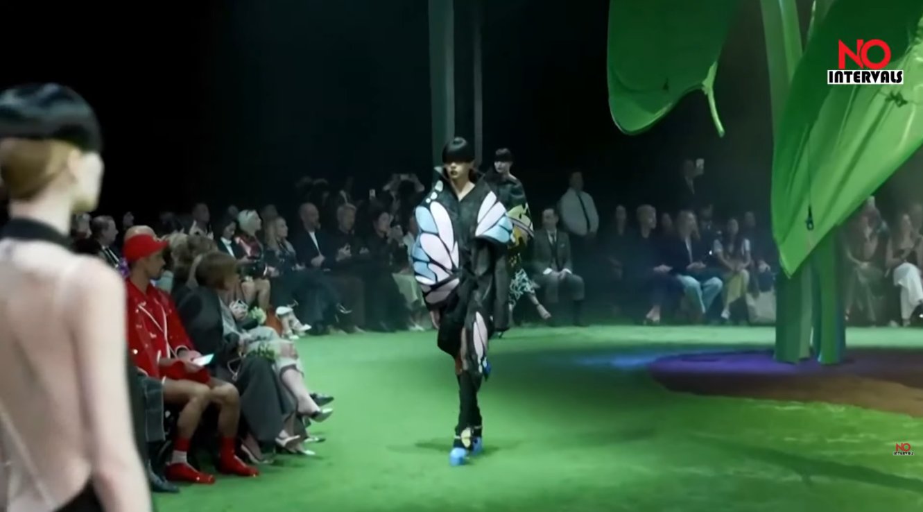 Backstage, some pumps featured 3D winged insects perched right on the vamp, while other looks paired classic Thom Browne brogue pumps with his signature red-white-and-blue crisscross leg straps, tying the bug motif directly into the house's existing tricolor branding.