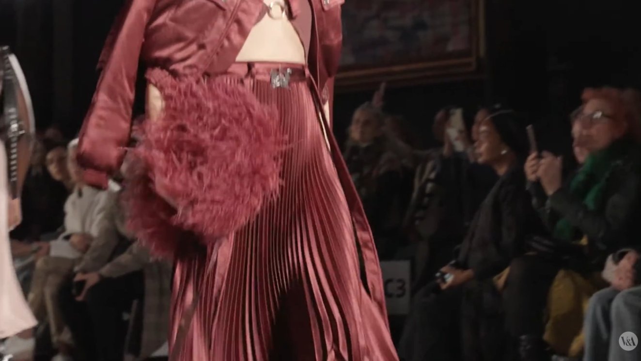 The collection is built as a direct argument with a 124-year-old economic theory. Magugu explicitly frames "Discard Theory" as a "trickle-up" answer to Thorstein Veblen's 1899 "trickle-down" theory of fashion, turning a piece of 19th-century economics into the conceptual skeleton of a 21st-century runway show.