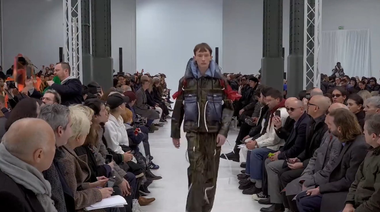The cashmere on the runway was designed to be felt but not touched. The dresses that opened the show had a protective layer sewn underneath the cashmere, meaning the models were physically prevented from feeling the very fabric they were wearing.