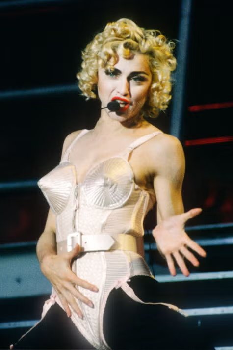 Which designer created Madonna's cone bra corset for the 1990 Blond Ambition World Tour?